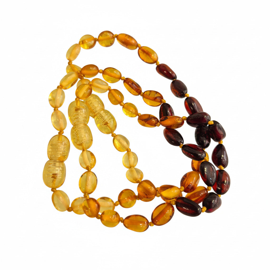 amber baby bracelets with varying shades of brown and yellow on a white background