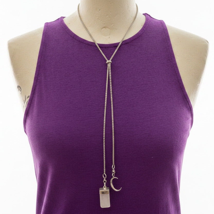 Purple tank top with a long necklace on a mannequin against a white background