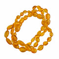 Amber teething bracelet on a white background