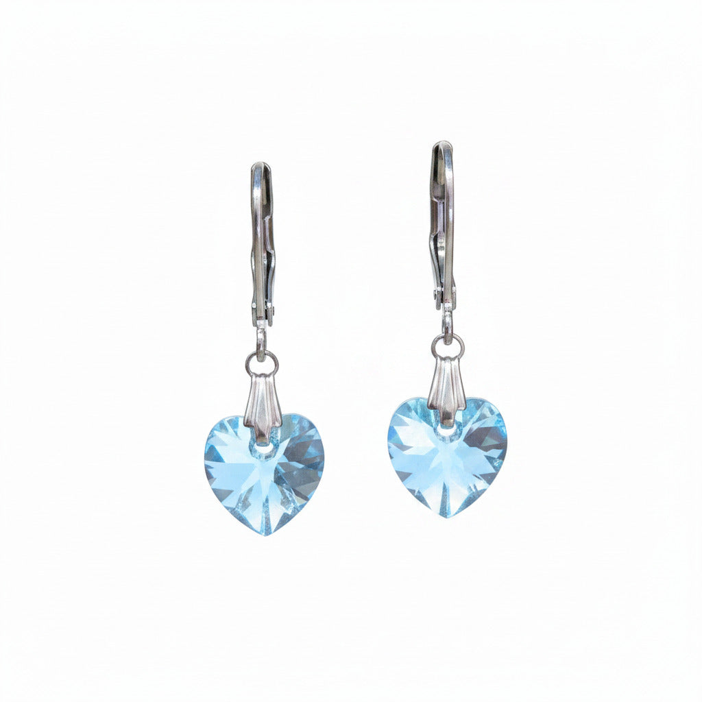 Pair of earrings with light blue swarovski crystal heart on a white surface