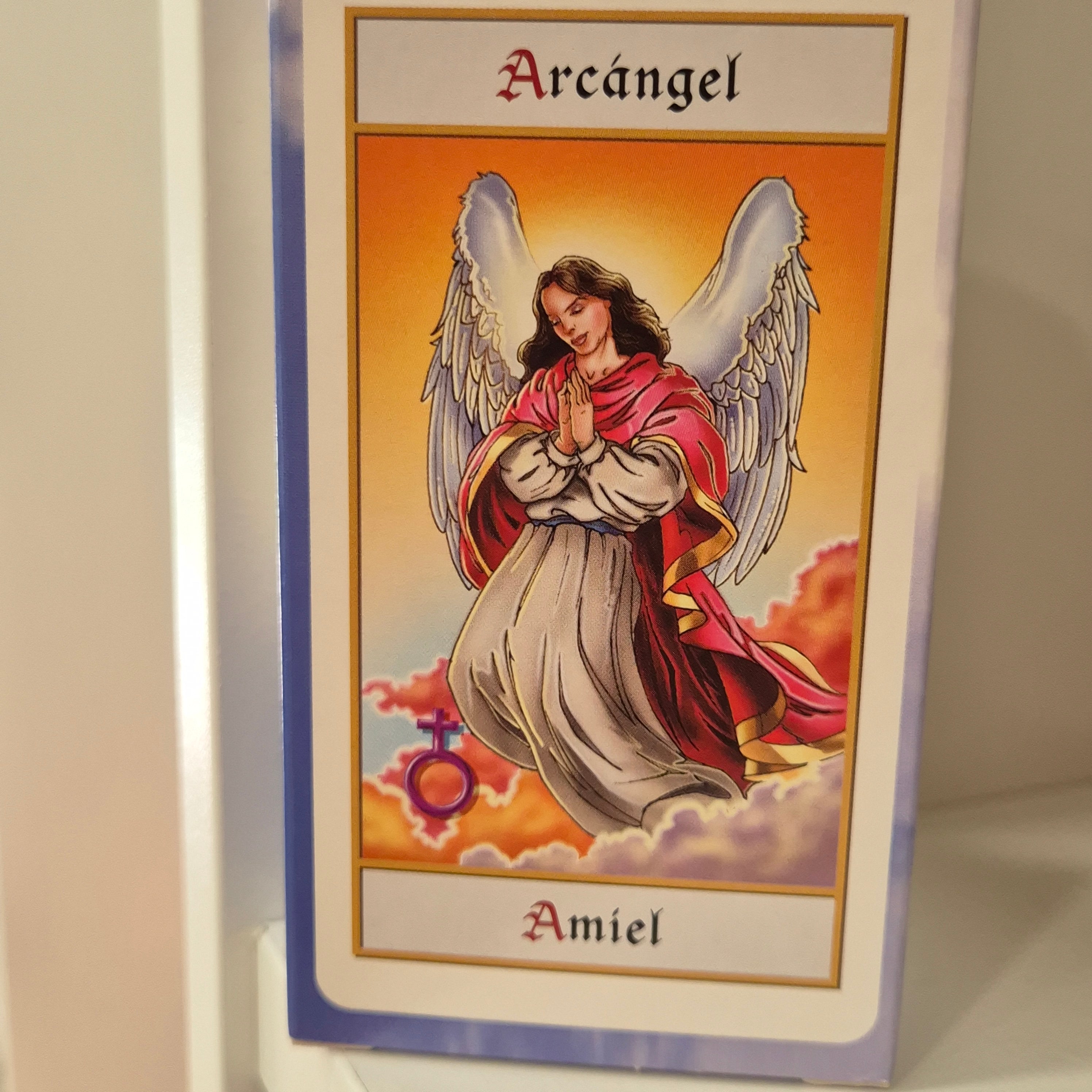 Card featuring an angel with wings and a red robe on a beige background