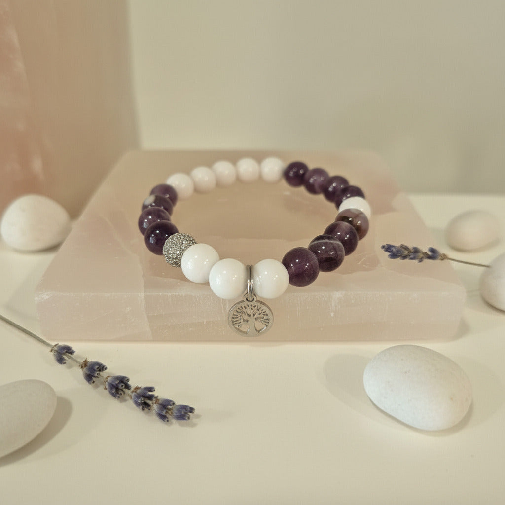 Beaded bracelet with purple and white beads on a light background