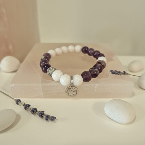 Beaded bracelet with purple and white beads on a light background