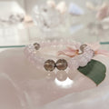 Beaded bracelet with pink and silver beads on a white surface