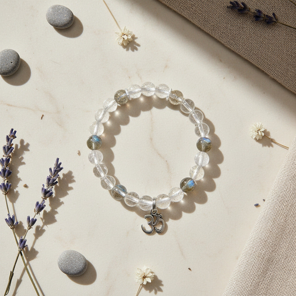 Crystal bracelet with OM charm on a neutral background with lavender and stones