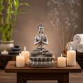 Silver Buddha statue on a white background