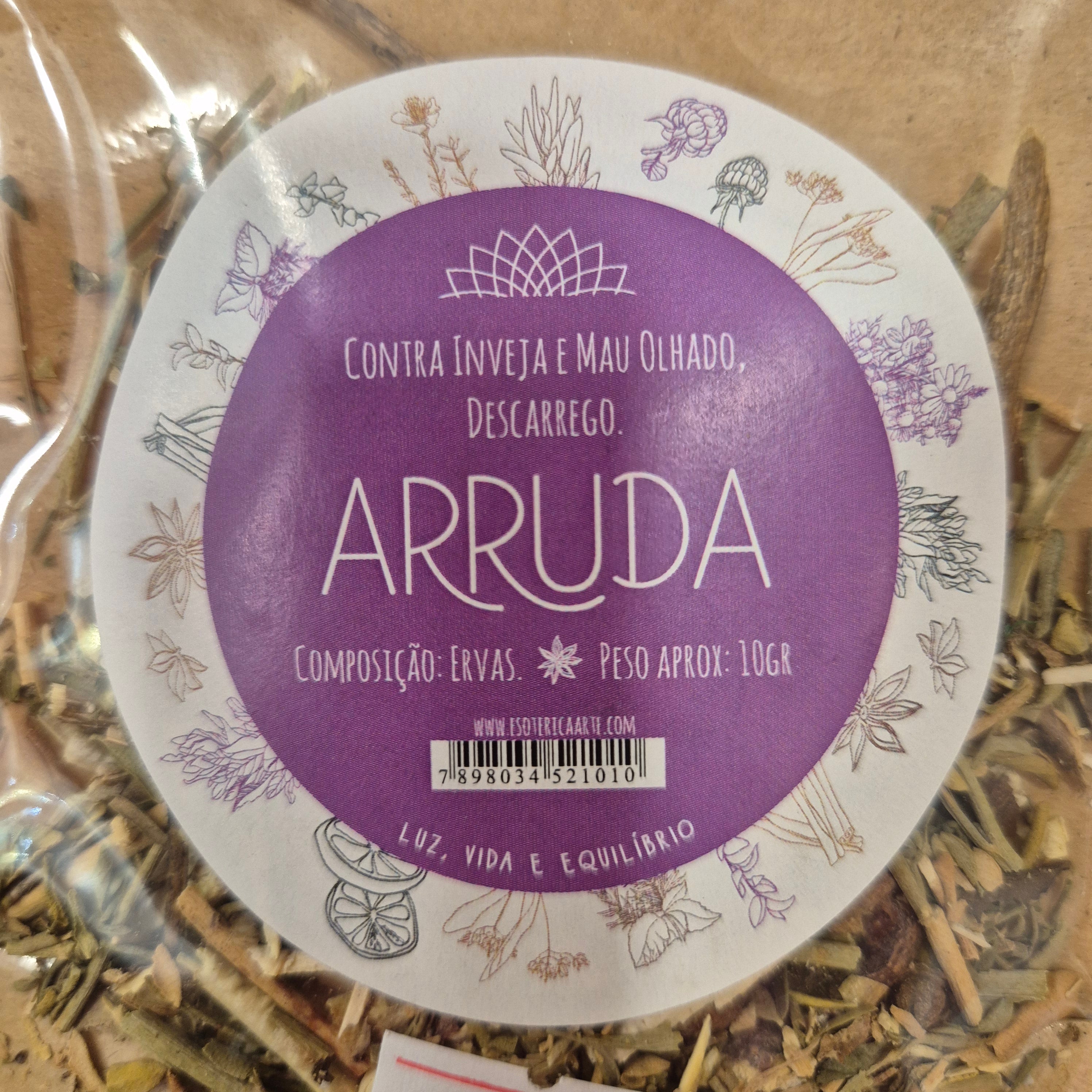 Round purple and white label with 'ARRUDA' branding on a background of dried herbs.