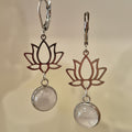 Lotus flower earrings with natural stone pendants on a beige background