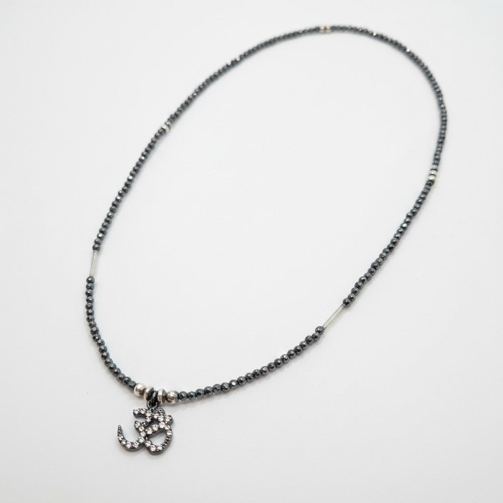 Necklace with small charm on a light gray background