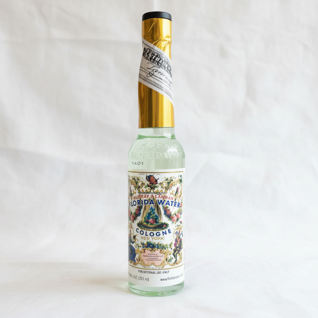 Bottle of Florida Water cologne with decorative label on a white background