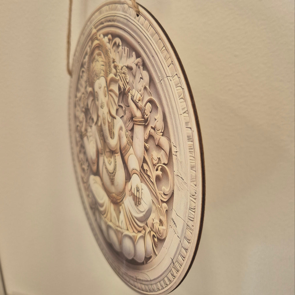 Decorative wall plaque with intricate design on a beige wall.