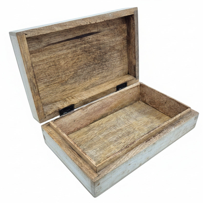 Wooden jewelry box with a hinged lid on a white surface