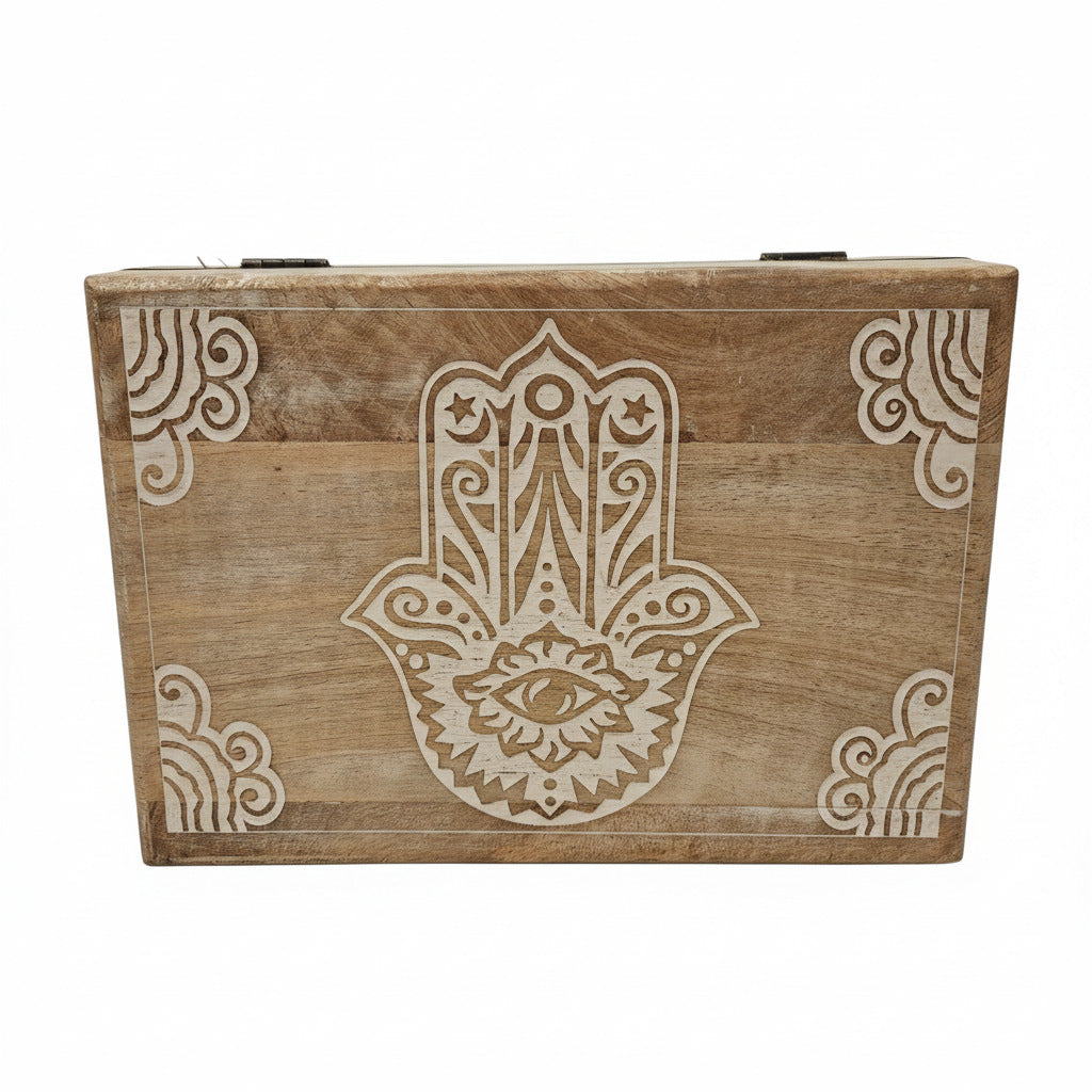 Wooden block with Hamsha design on a white surface