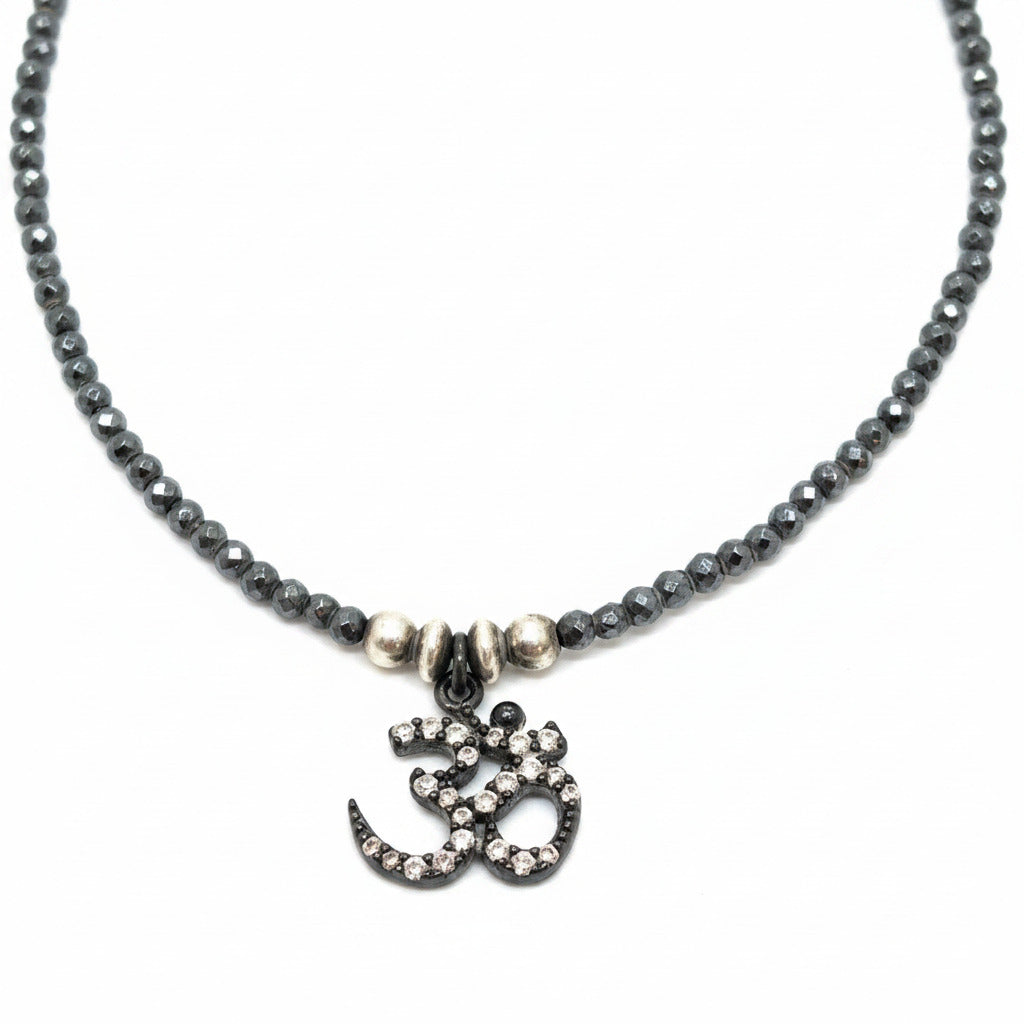 Necklace with Om symbol pendant on a white background