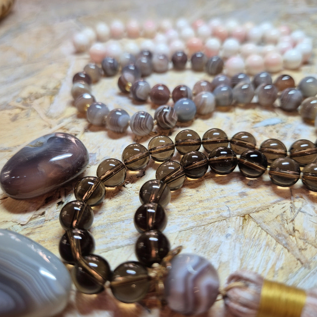 Set of beaded necklaces on a wooden surface