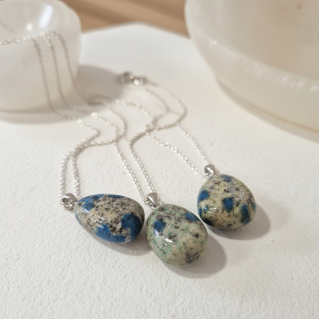 K2  jasper stone pendants on chain on a white surface