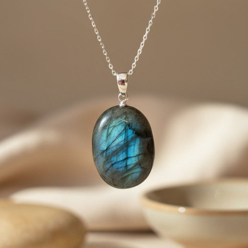 labradorite stone hanging against a plain background