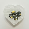 Four Labradorite stones on a heart-shaped white stone