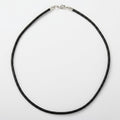 Black necklace with a silver clasp on a white background