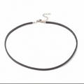 Black choker necklace on a white background
