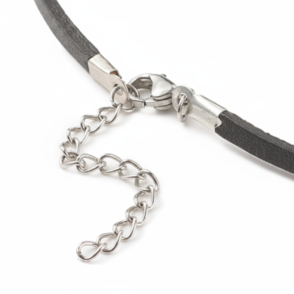 Close-up of a silver clasp on a black cord against a white background