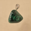 Green malachite pendant on a white background