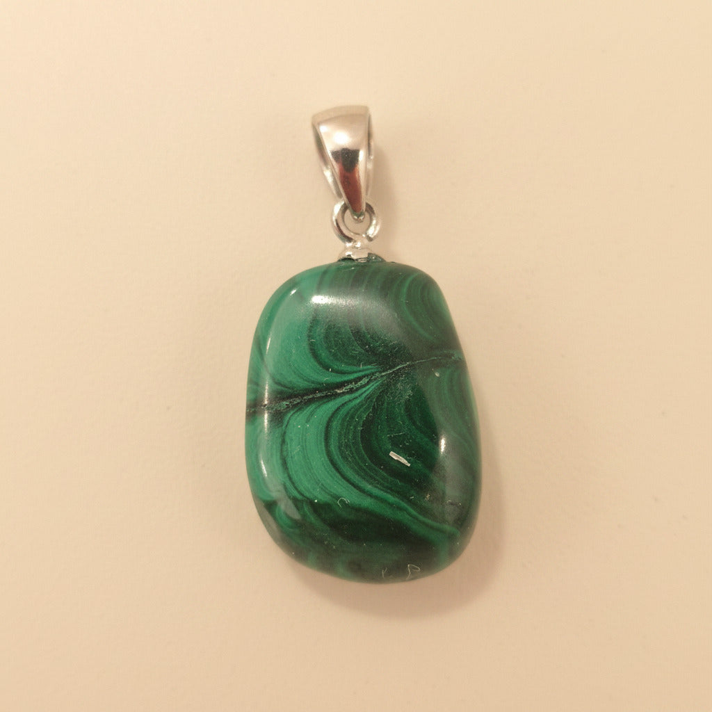 malachite pendant on a beige background