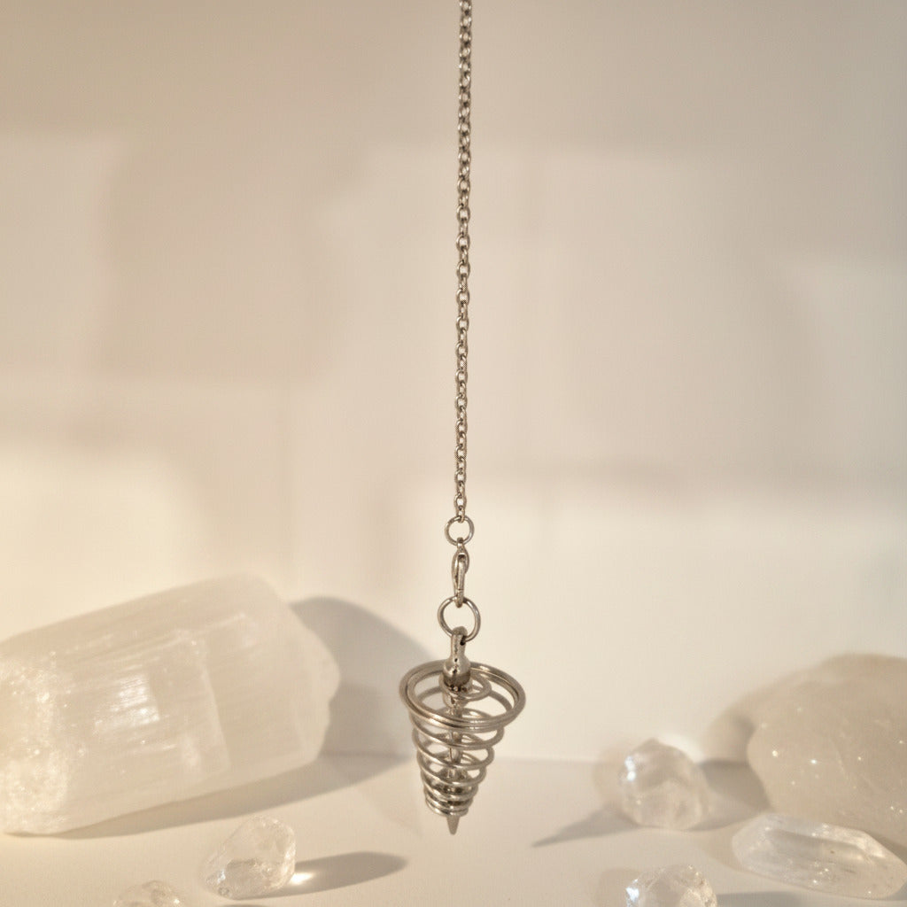 Metallic spiral pendulum on a chain with a neutral background