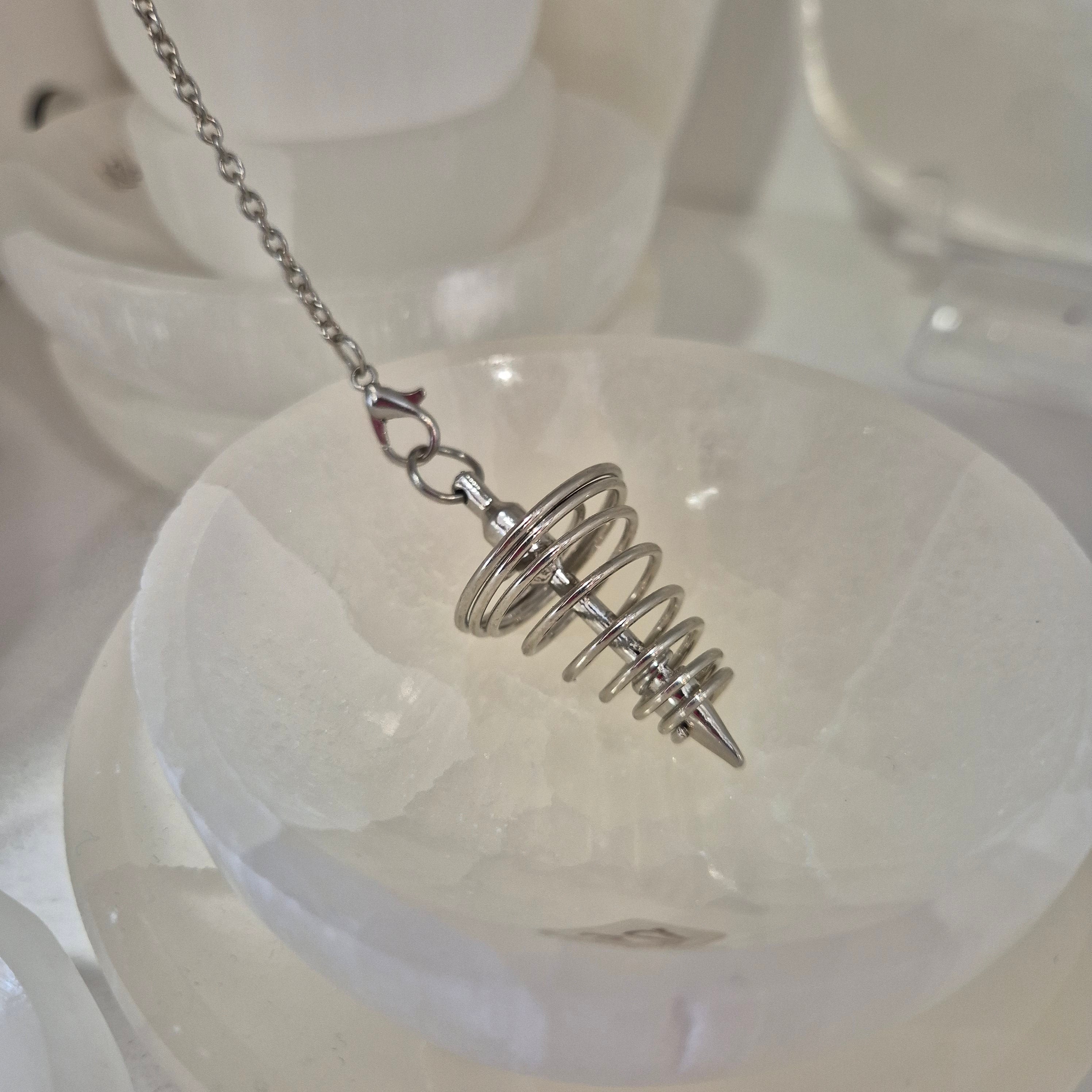 Silver spiral pendulum on a chain against a white background