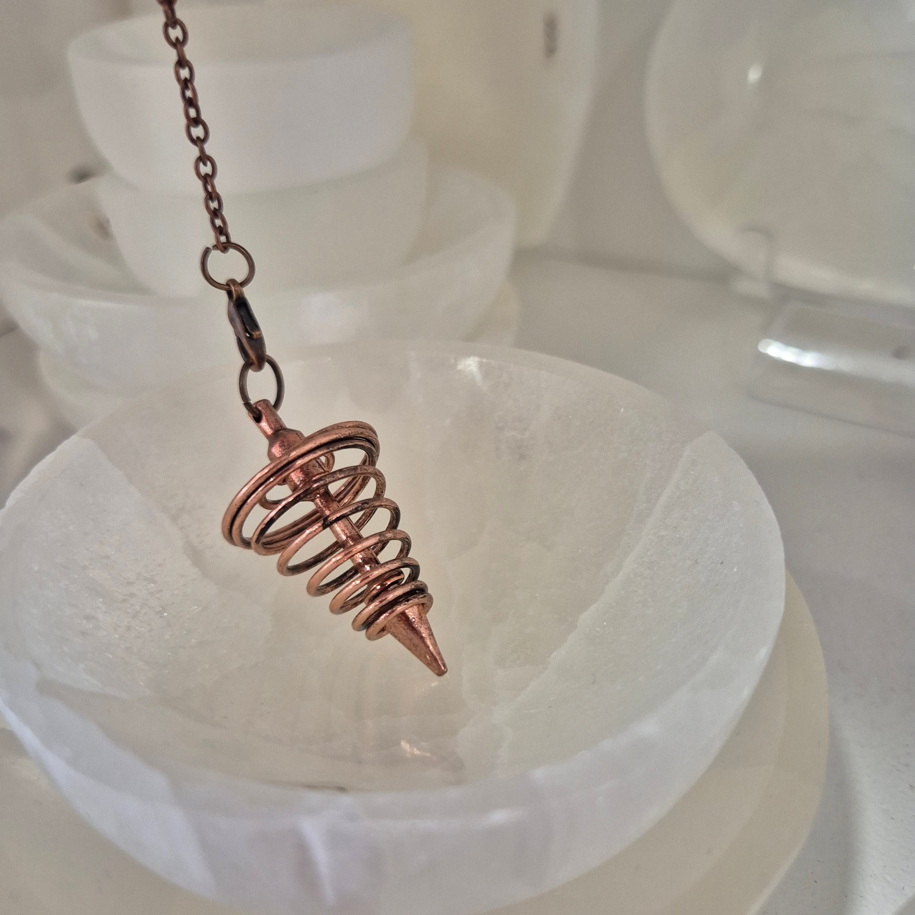 Metal pendulum in bronze color on chain
