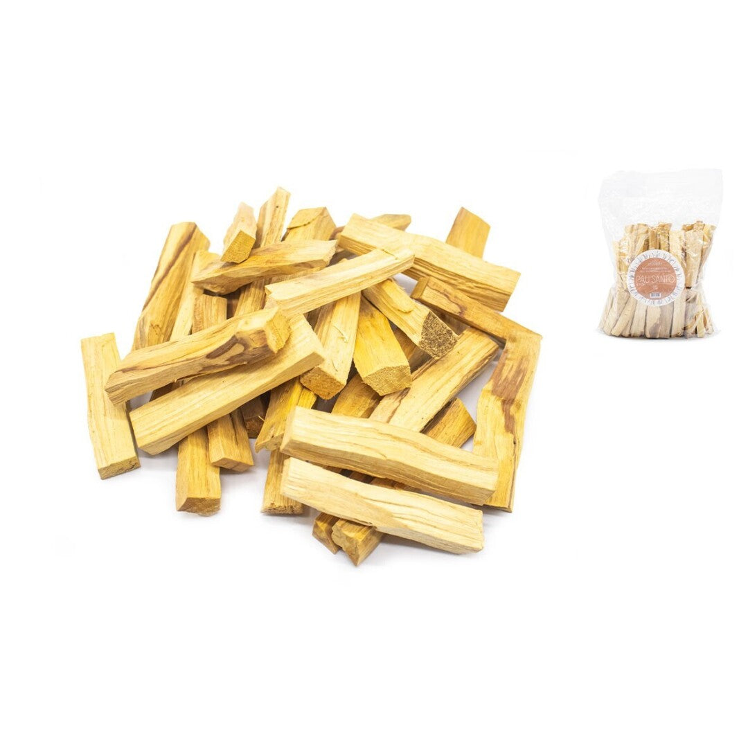 Pile of wooden sticks on a white background with a smaller pile and packaging in the corner.