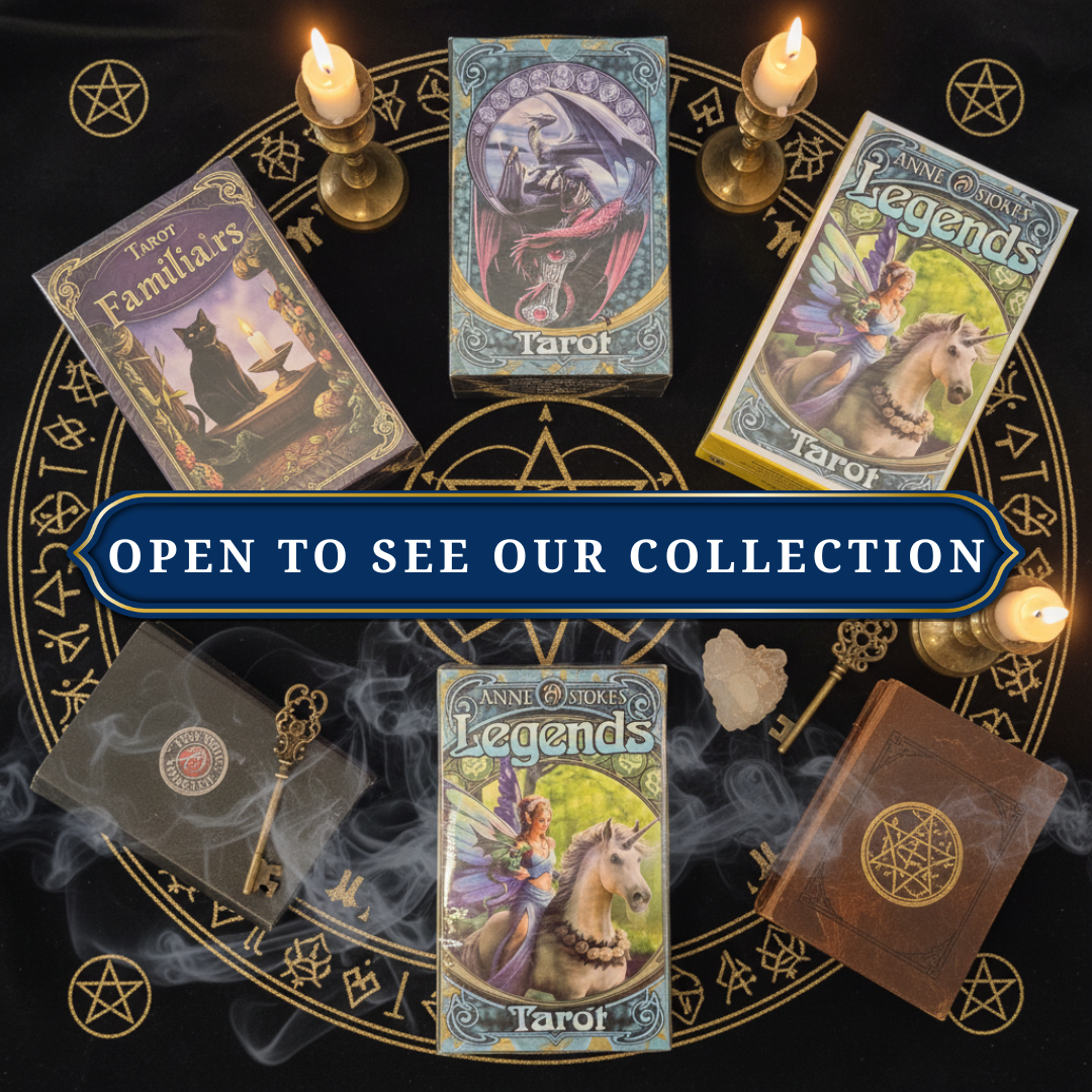Collection of tarot cards on a dark background with candles and mystical symbols.