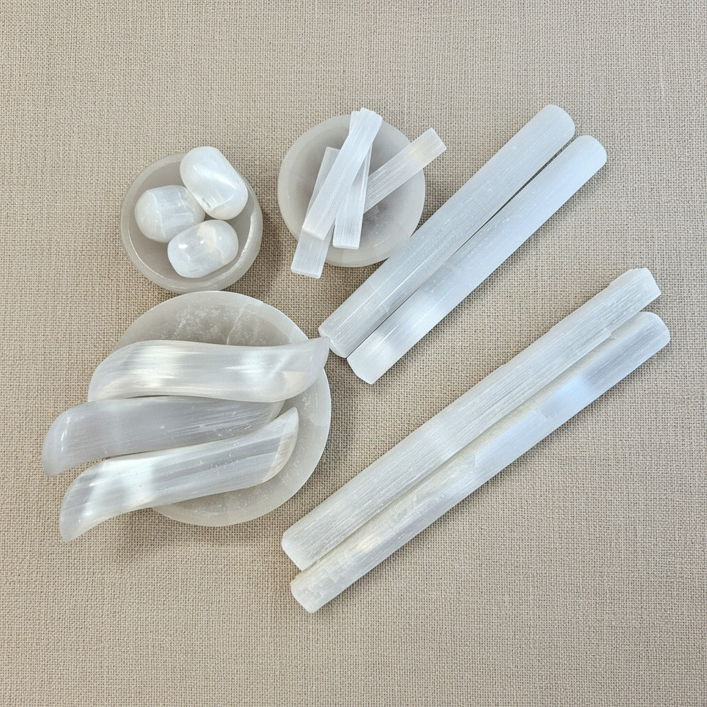 White crystal sticks and stones on a wooden surface 