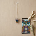 chakra pendulum on chain with tarot card