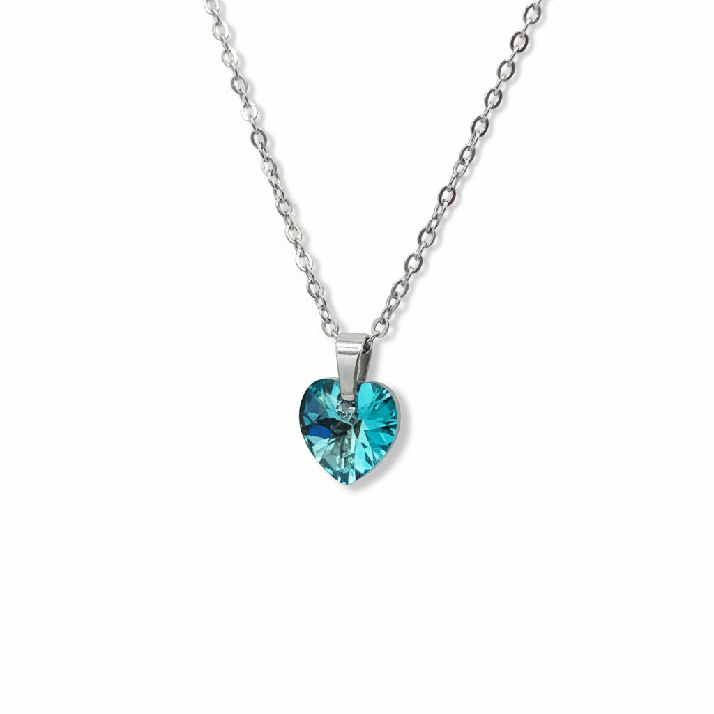 Necklace with a blue heart-shaped pendant on a light gray background