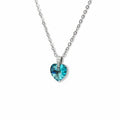 Necklace with a blue heart-shaped pendant on a light gray background
