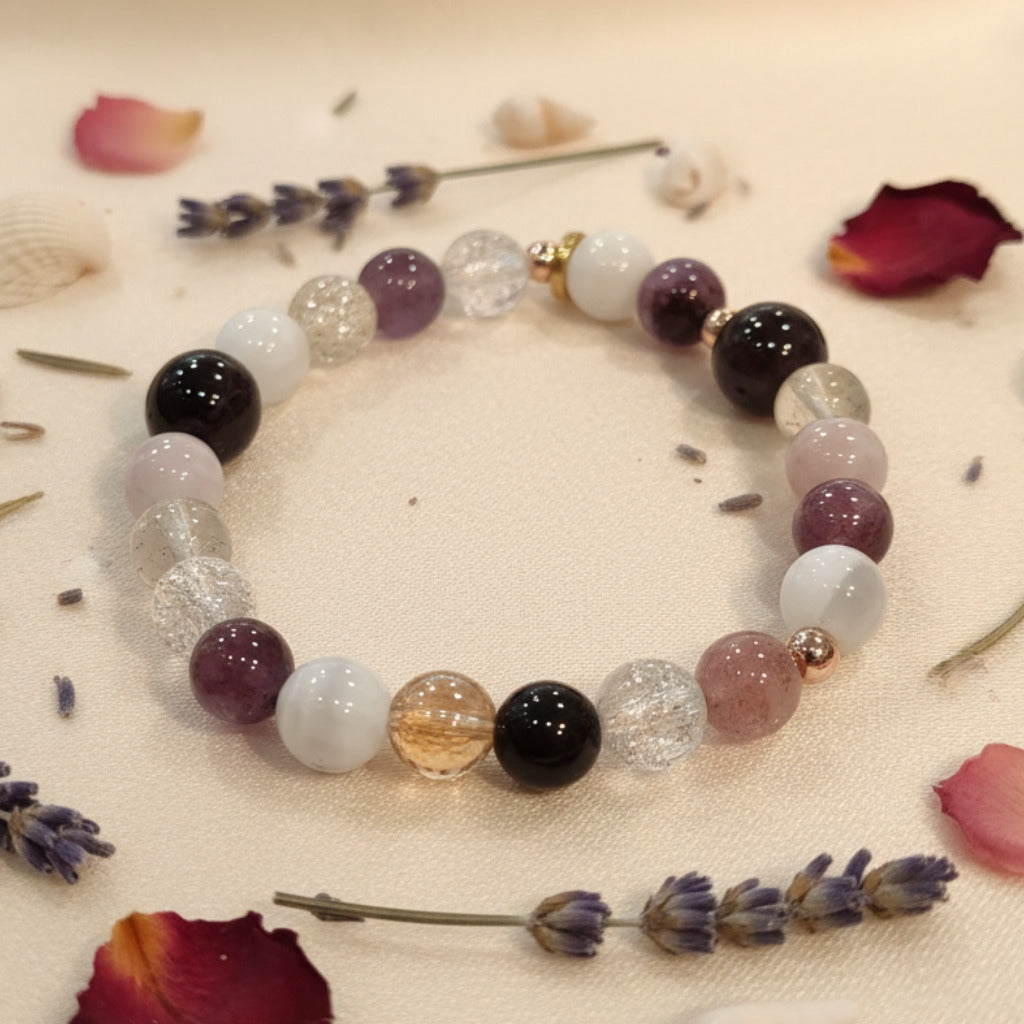 Beaded bracelet with multicolored beads on a textured surface with dried flowers and herbs