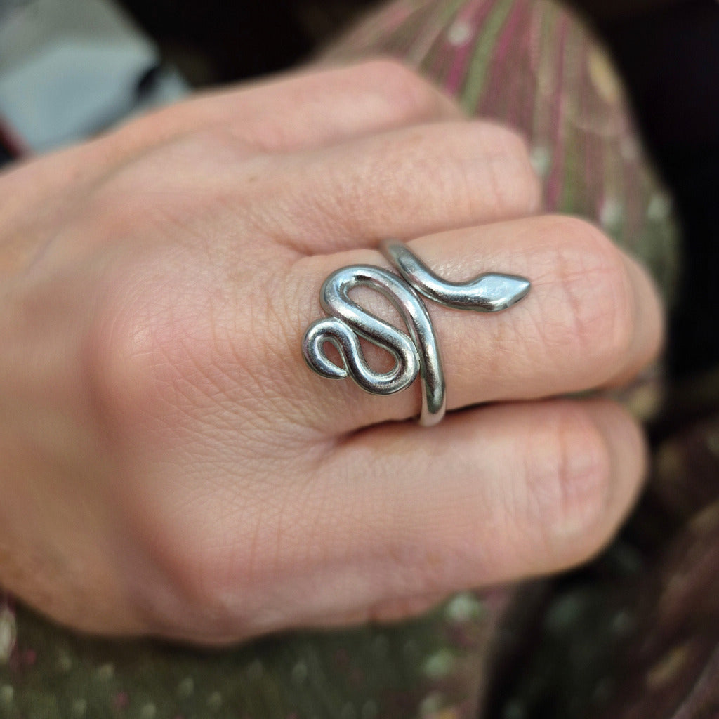 silver color Snake ring on middle finger