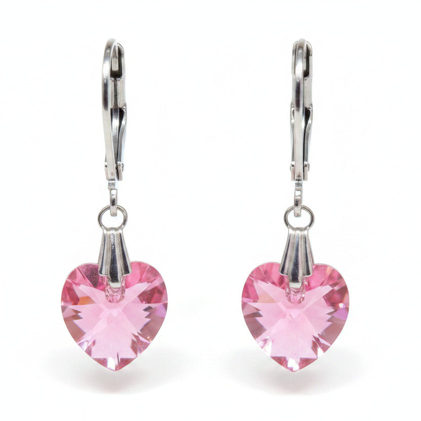 Pink heart-shaped earrings with silver hooks on a white background