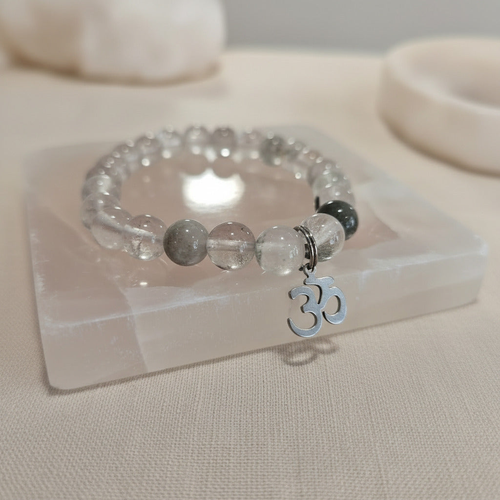 Bracelet with beads and OM charm on a clear stand