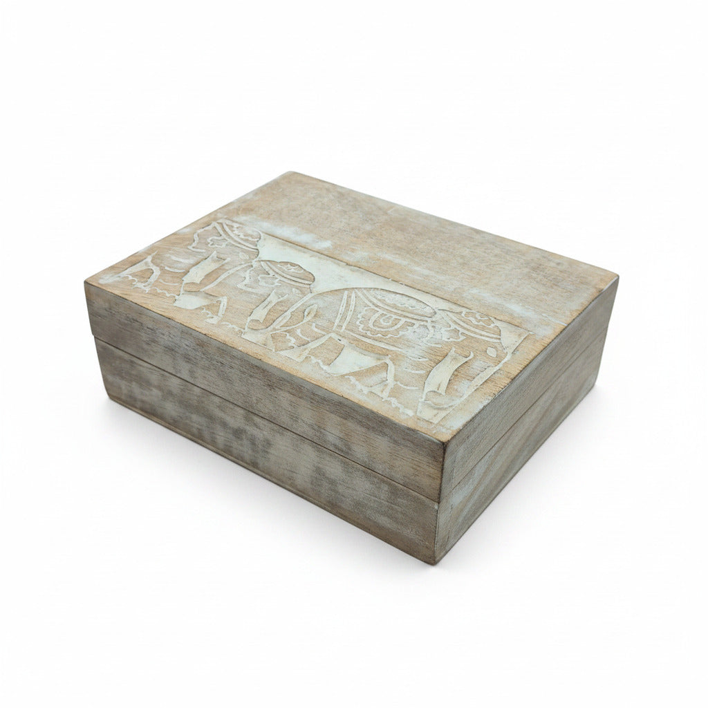 Wooden box with elephant carving on white surface