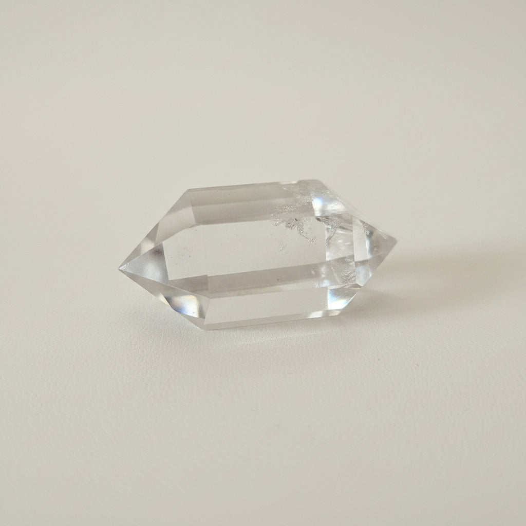 biterminated Crystal prism on a white surface