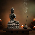Buddha statue with incense and candles on a wooden platform