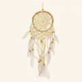 White dreamcatcher with feathers on a beige background