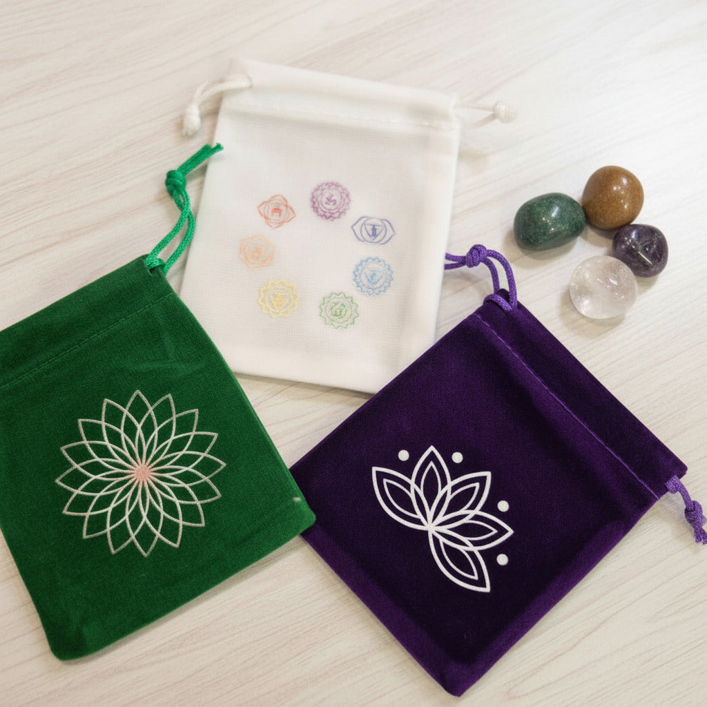 Chakra-themed velvet pouches with lotus designs, ideal for crystal storage and spiritual practices