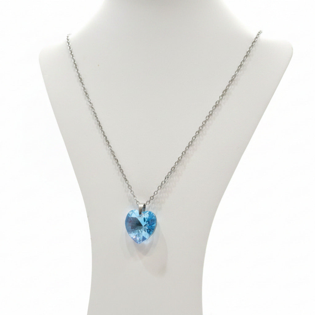 Necklace with a blue heart-shaped pendant on a white card with a white background