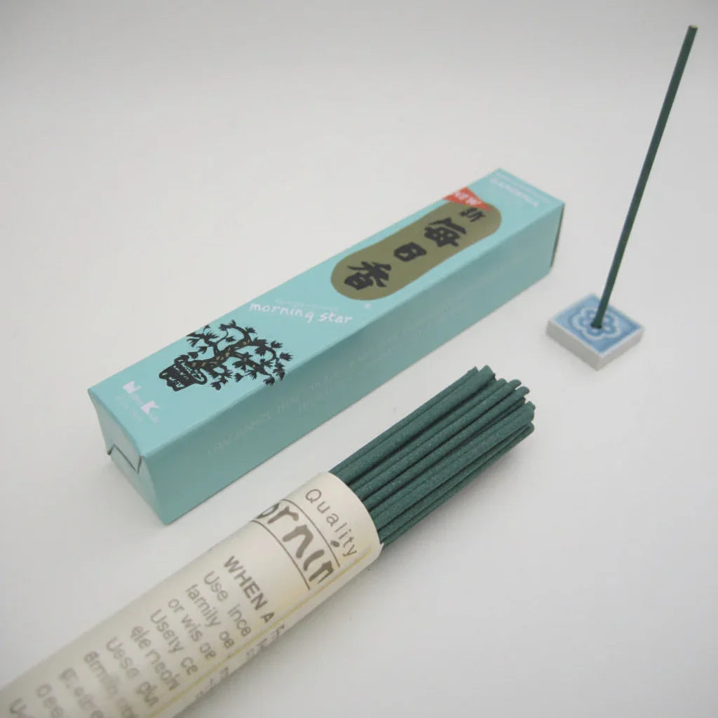 Incense sticks with a blue box on a light gray background