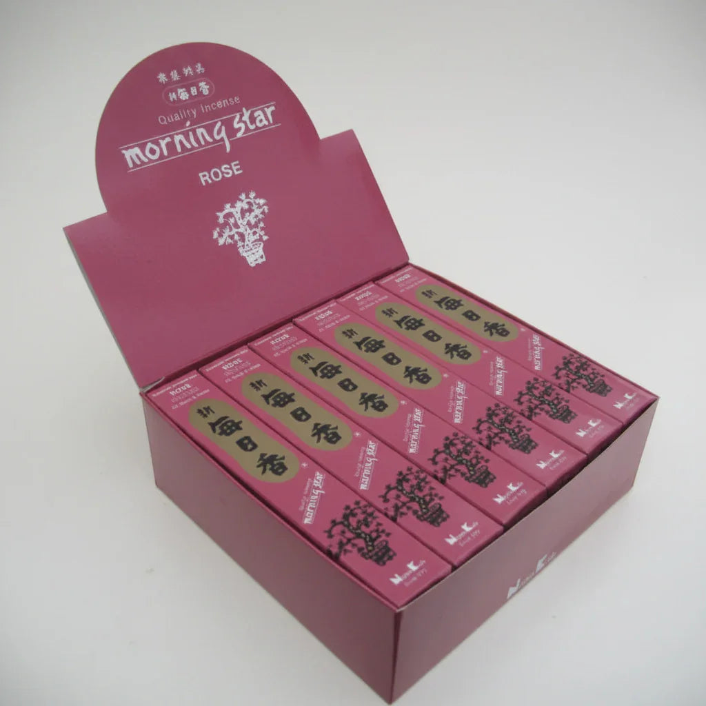 Open pink box of 'Morning Star Rose' tea packages on a white background