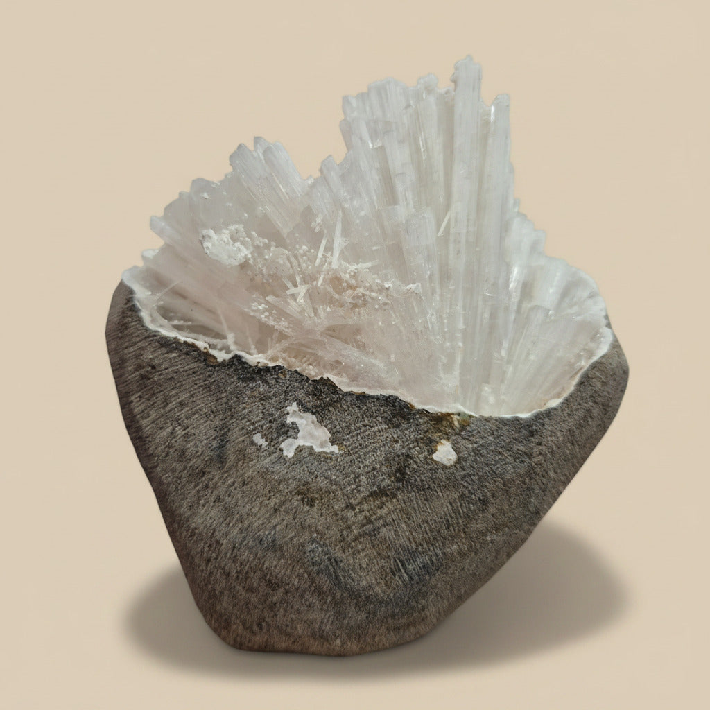 Crystal formation on a stone base against a beige background