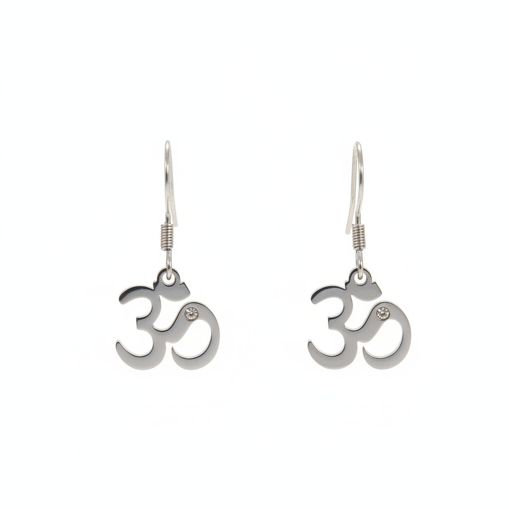 Pair of Om symbol earrings on a black earring holder against a beige background